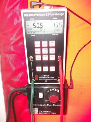 A manometer is used to measure pressure differentials between indoors and outdoors when testing whole-house air leakage.