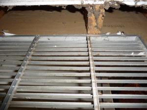 Wrong: open wall cavity connected to this return air plenum is allowing cellulose attic insulation to be pulled into the furnace
