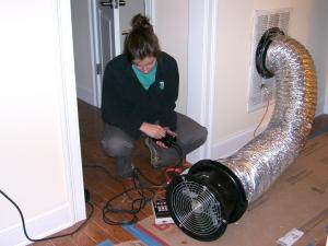 An energy rater uses a duct blower to test HVAC duct air leakage.