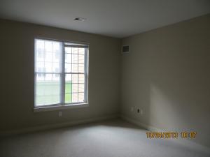 Right – A transfer grille is installed high on a bedroom wall in a new-construction home