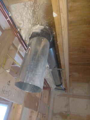 Right – This kitchen exhaust fan duct is made of smooth round steel duct that takes the shortest, most direct route to the outdoors and joints are sealed with mastic. 