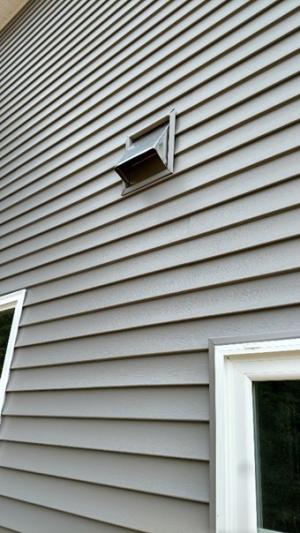 Right - The kitchen exhaust duct termination is integrated aesthetically and functionally with the exterior cladding; however, the opening should be screened to keep out pests. 