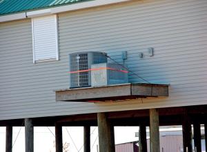 Right – The HVAC compressor sits on a raised cantilever platform away from the base flood elevation. 