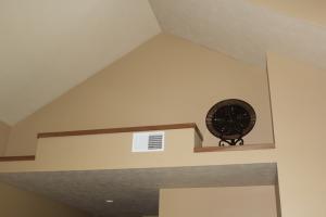 A ductless heat pump is hidden behind a wall outcropping above the hallway ceiling. 