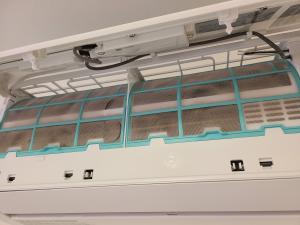 In this ductless heat pump model, the air filters are located behind the hinged front panel