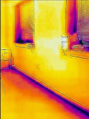 Wrong - This IR image is showing a lack of air-sealing is allowing cold air to enter the home around the windows and at the base of the wall.