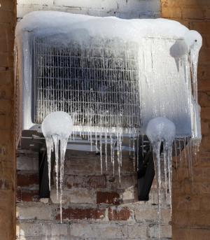 Overflowing ice dams can cause damage to HVAC equipment located below.
