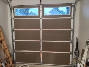 This garage door has been insulated with pieces of rigid foam and canned spray foam.
