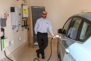 Solar electric panels provide electricity for the home and an electric car charging station.