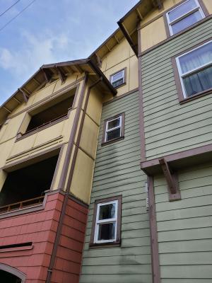 Wrong - The gutter is missing kick-out flashing causing wall and window damage beneath it.