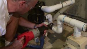 A reciprocating saw works well to cut PVC pipe during pool pump installation