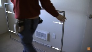 Locate the holes on the sides of the panel frame that will allow it to be screwed into place.