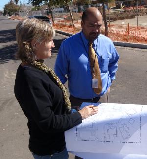 A developer meets with a landscape architect at the site.