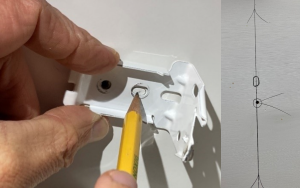 Mark other holes in the mounting bracket by holding the bracket in place. Drill pilot holes for these marks.
