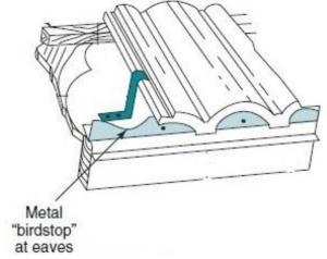 Metal birdstop is installed at the eaves of a tile roof to keep out birds, bats, rodents, and flying insects 