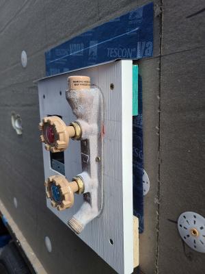 Right - Metal drip edge flashing is installed above hose bib and top of metal flashing is taped to wall.