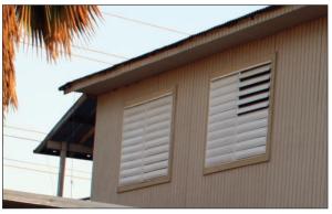 In tropical climates such as Puerto Rico, some houses have metal jalousie louvers instead of glass windows; metal jalousies look like shutters, but typically offer little debris resistance. 