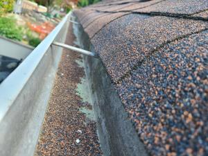 Wrong - No metal drip edge is visible and asphalt shingles hang down too far.