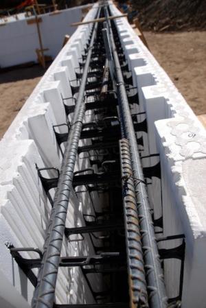 ICF blocks used for the foundation walls consist of two sheets of rigid foam held together by plastic spacers and reinforced with steel bars forming a hollow wall that is filled with concrete for an ultra-efficient foundation system.