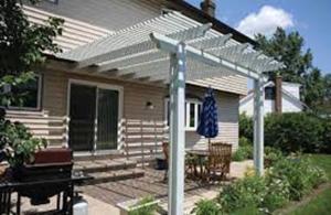 The south face of this home has an overhanging second floor, a pergola, and a roof eave to provide effective window and door shading for both floors in the summer without blocking view, diffuse daylighting, breezes, or ingress/egress