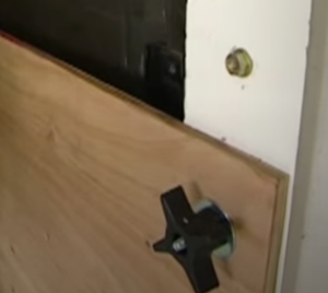 Right - Plywood storm protection covering for windows is installed with removable threaded-rod fittings. 