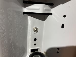 After removing the light bulb from this combination exhaust fan/light, the housing for the light can be removed by unscrewing this nut