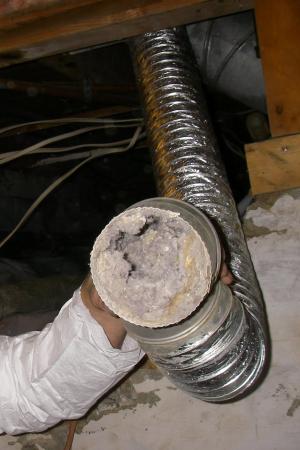 Wrong –Excessive length and a vertical angle on this dryer duct reduced air flow allowing the dryer duct to become completely clogged with dryer lint