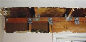 Add metal connectors to strengthen framing connections in an existing wall from inside the home by removing drywall. 