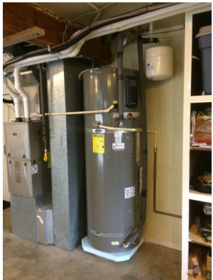 Right: This heat pump water heater is installed in a garage next to the furnace where there is a lot of space for accessing the unit, and for intake and exhaust; a foam pad insulates the base; the condensate line is correctly drained and pipe insulation
