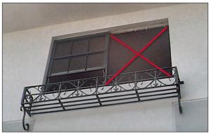 The right window frame was pulled out of the wall because of inadequate window frame attachment during a hurricane.