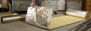 Insulation for rigid ducts comes in large rolls like this 4-ft x 50-ft roll consisting of a Foil-Scrim-Kraft (FSK) vapor barrier attached to the fiberglass insulation.