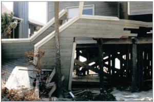 The rails on these stairs were enclosed with siding, presenting a greater obstacle to the flow of flood water and contributing to the flood damage shown here. 