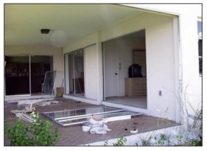 Anchorage failure in sliding glass doors due to negative pressures from hurricane force winds.