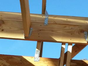 Bolted metal hurricane strapping ties the roofing to the framing and the framing to the foundation walls for resistance to high winds.