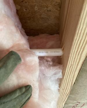 Pipes and wires in a crawlspace or basement are often concealed by insulation which can be pulled back while wearing gloves, long sleeves, glasses, and a well-fitting dust mask.