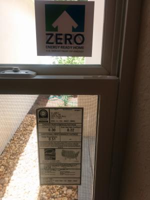 This home bears a DOE Zero Energy Ready Home label on its front window next to the ENERGY STAR window label.