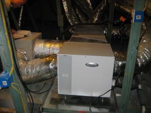 A supplemental dehumidifier is integrated with the home’s HVAC air handler to provide extra dehumidification when needed