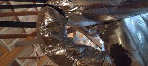 Wrong - The support strap for the duct is too tight and the radius of the turn is too sharp.