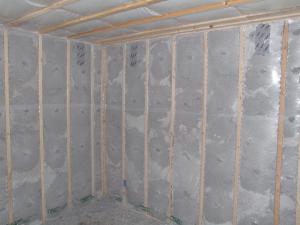 Blown cellulose insulation completely fills the netted wall and ceiling cavities.