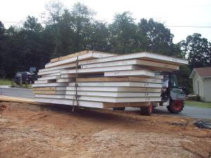 An all-terrain forklift is used to move and stage the panels