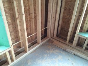 Right – A gap separates the two wall layers in this double-stud wall assembly allowing room for insulation to stop thermal bridging between the inner and outer wall