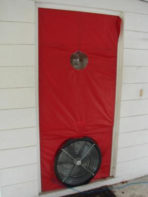 A blower door is installed in a doorway and is ready for testing