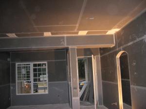 Drywall is installed, hiding the duct work