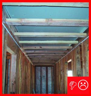 Wrong: Drywall does not extend beyond chase wall framing and is unsealed in a hallway dropped ceiling chase