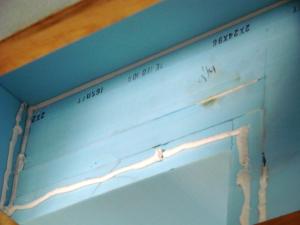 Second layer of rigid insulation is adhered with foam