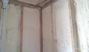 Closed-cell spray foam insulation is added to the wall cavities of an existing exterior wall