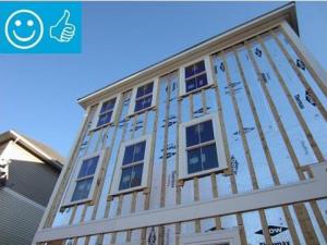 Right - Foil-faced polyisocyanurate rigid foam is attached to the existing exterior wall with vertical wood furring strips