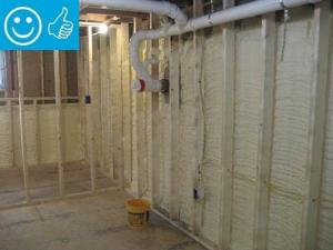 Right - Closed-cell spray foam covers the interior of the foundation wall and wall framing is placed to the inside of the spray foam.