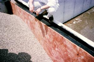 Rigid insulation is installed on the exterior side of the flat foundation wall