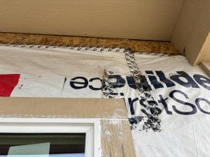 Right – The seams and edges of the house wrap have been taped but house wrap should have been extended up to porch roof and care should be taken to press the tape with a roller to activate tape adhesion.